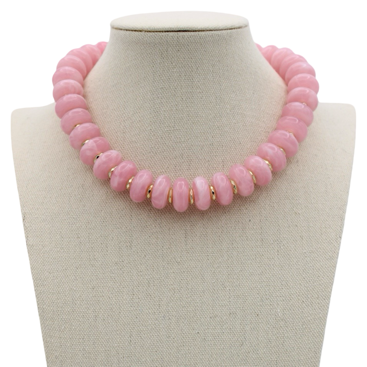 A pink beaded necklace displayed on a cream fabric-covered jewelry bust against a white background.